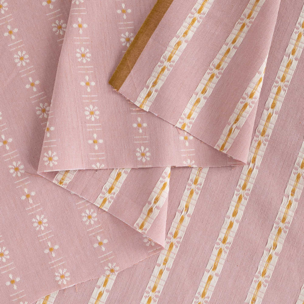 a close up of a pink and yellow striped fabric