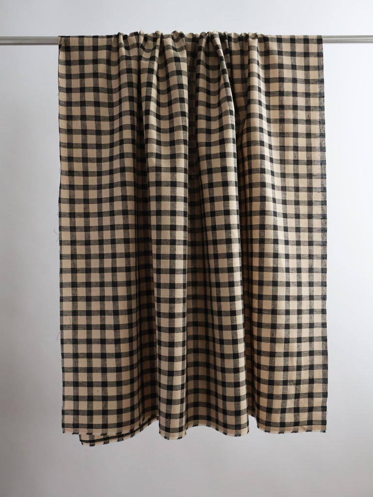 a black and white checkered curtain hanging from a metal rod