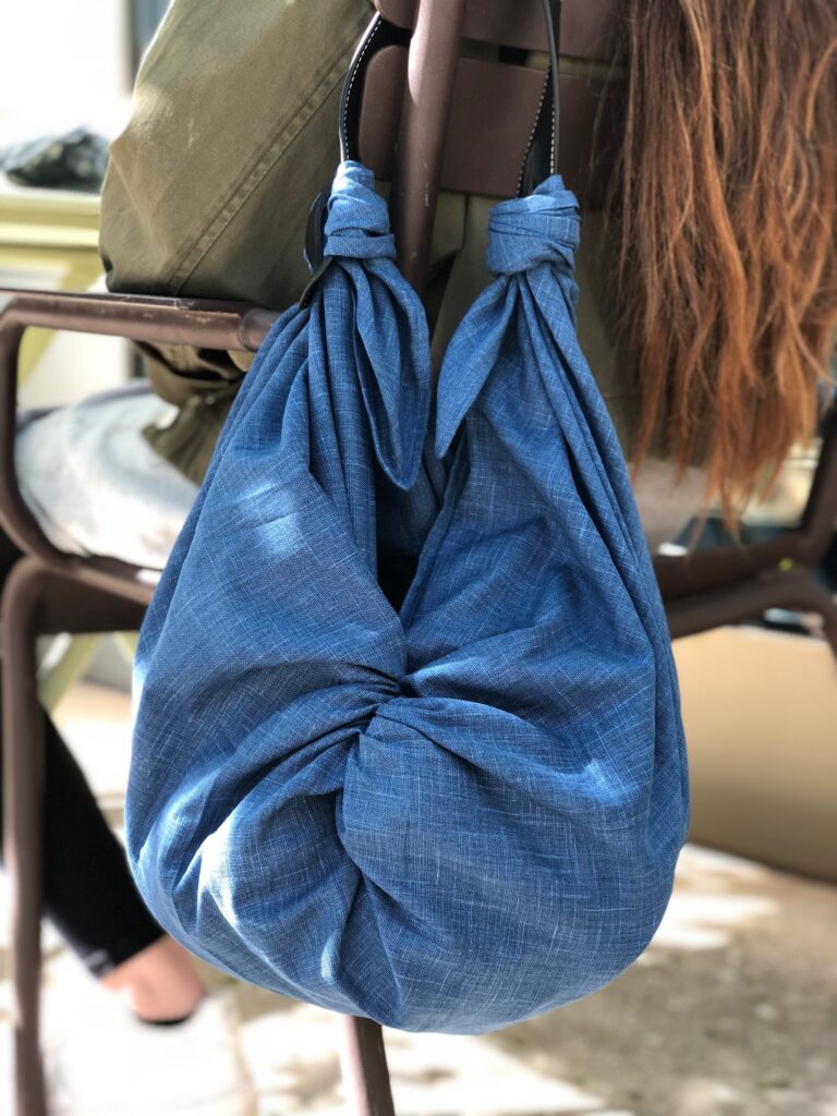 a woman sitting in a chair holding a purse