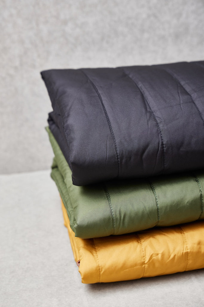 a stack of three pillows sitting on top of each other