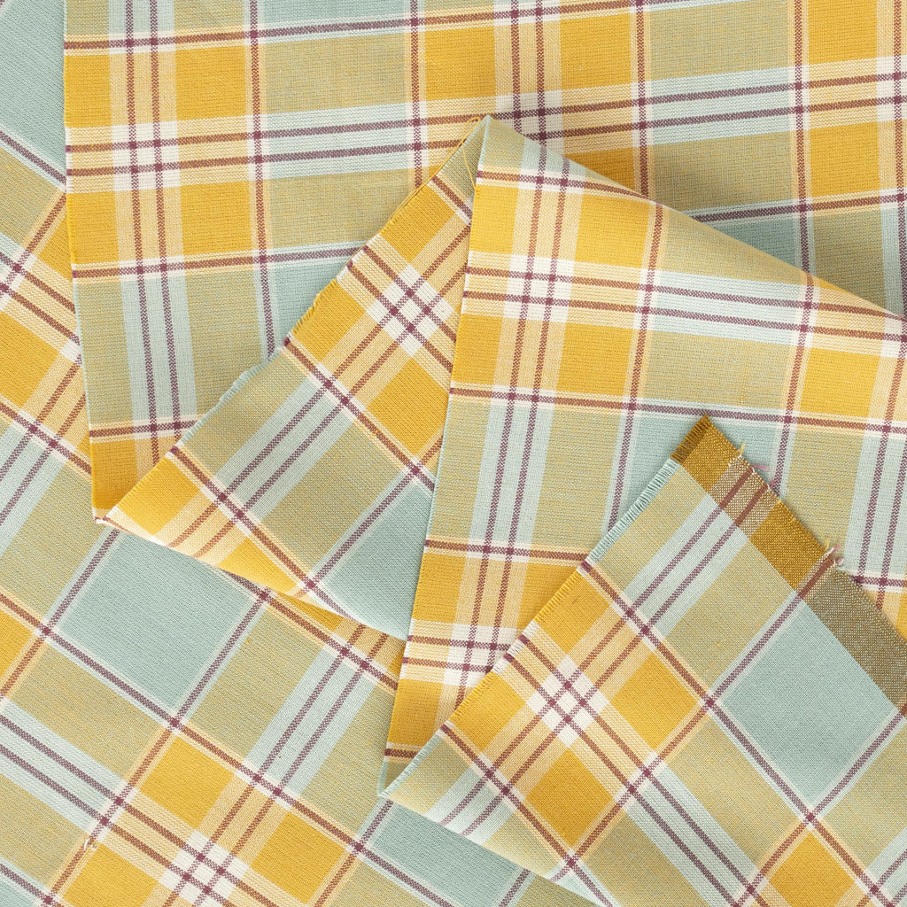 a close up of a yellow and blue plaid fabric