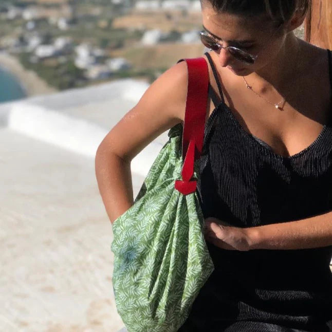 a woman in a black dress is looking at her cell phone