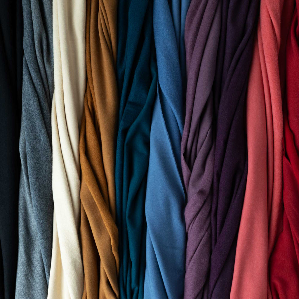 a bunch of different colors of fabric