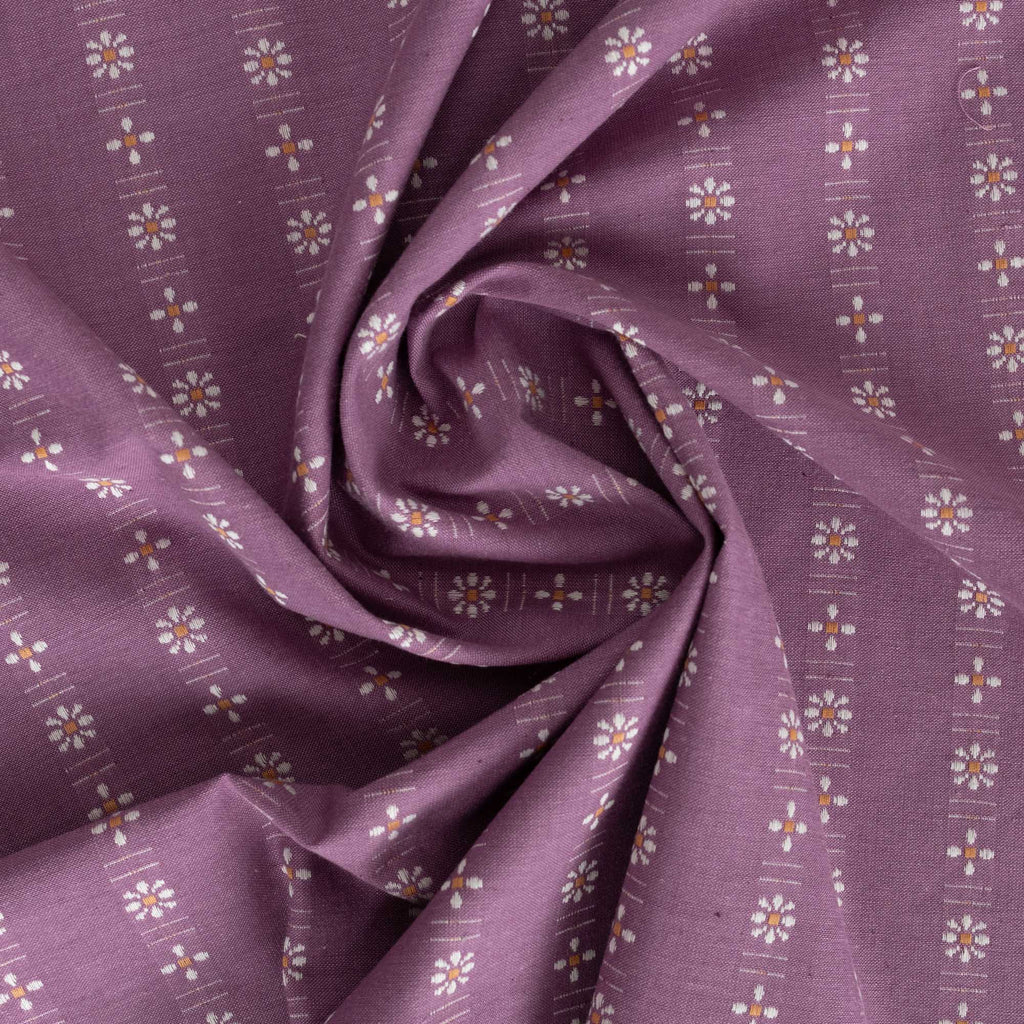 a purple fabric with white flowers on it