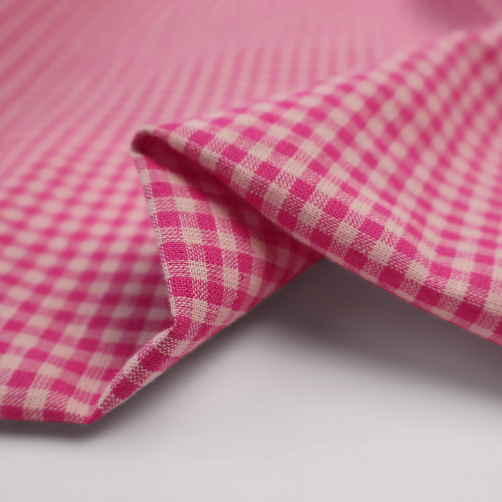 a close up of a pink and white checkered fabric