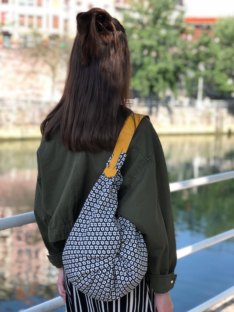 a woman standing on a bridge looking at the water