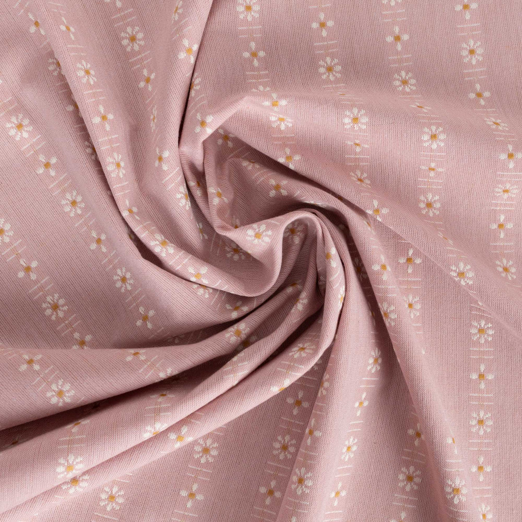 a pink fabric with white flowers on it