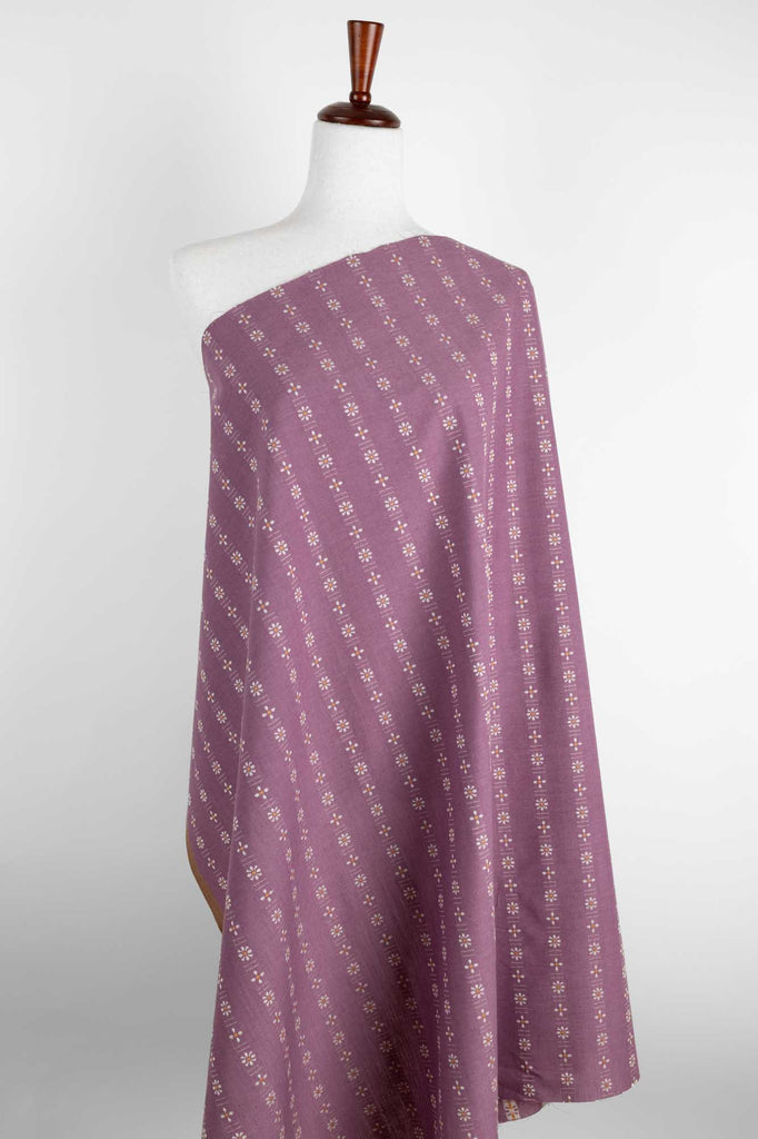 a purple and white blanket on a mannequin
