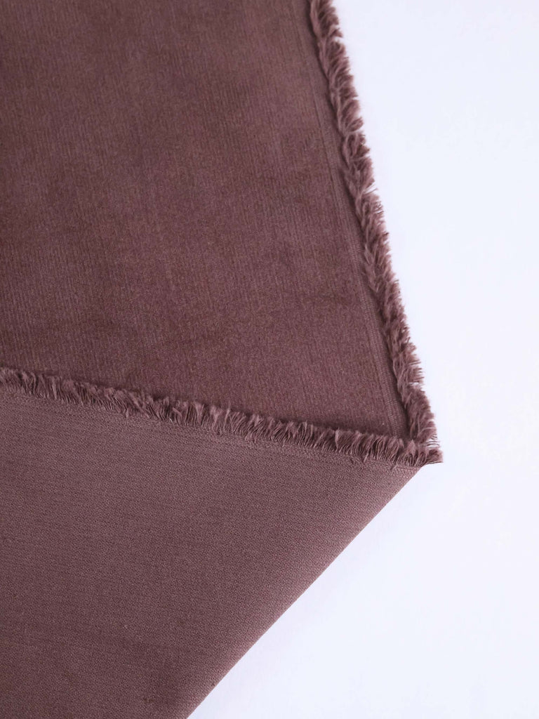 a close up of a piece of cloth on a white surface