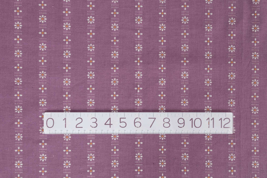 a ruler is on top of a purple fabric
