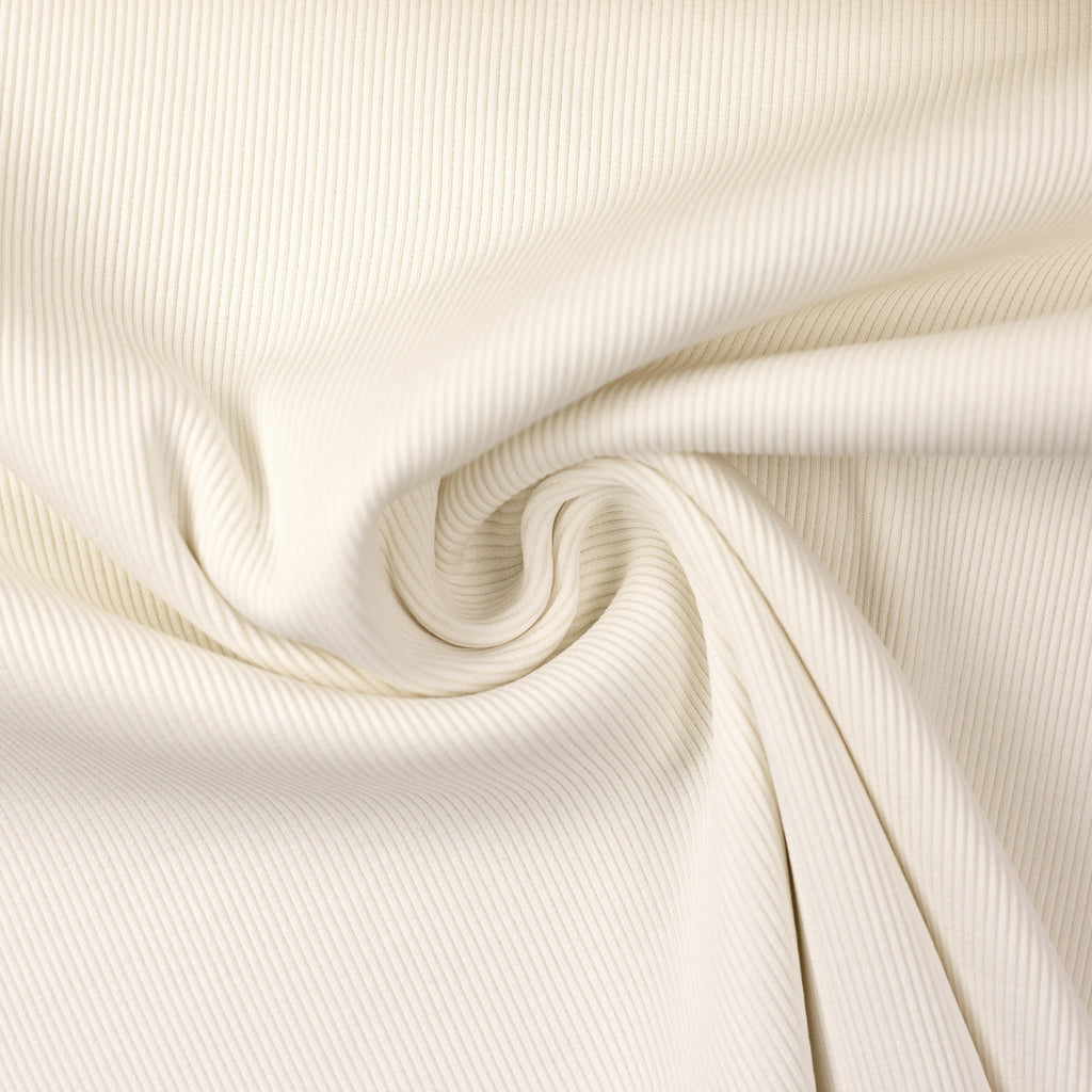 Close-up of cream rib knit fabric.