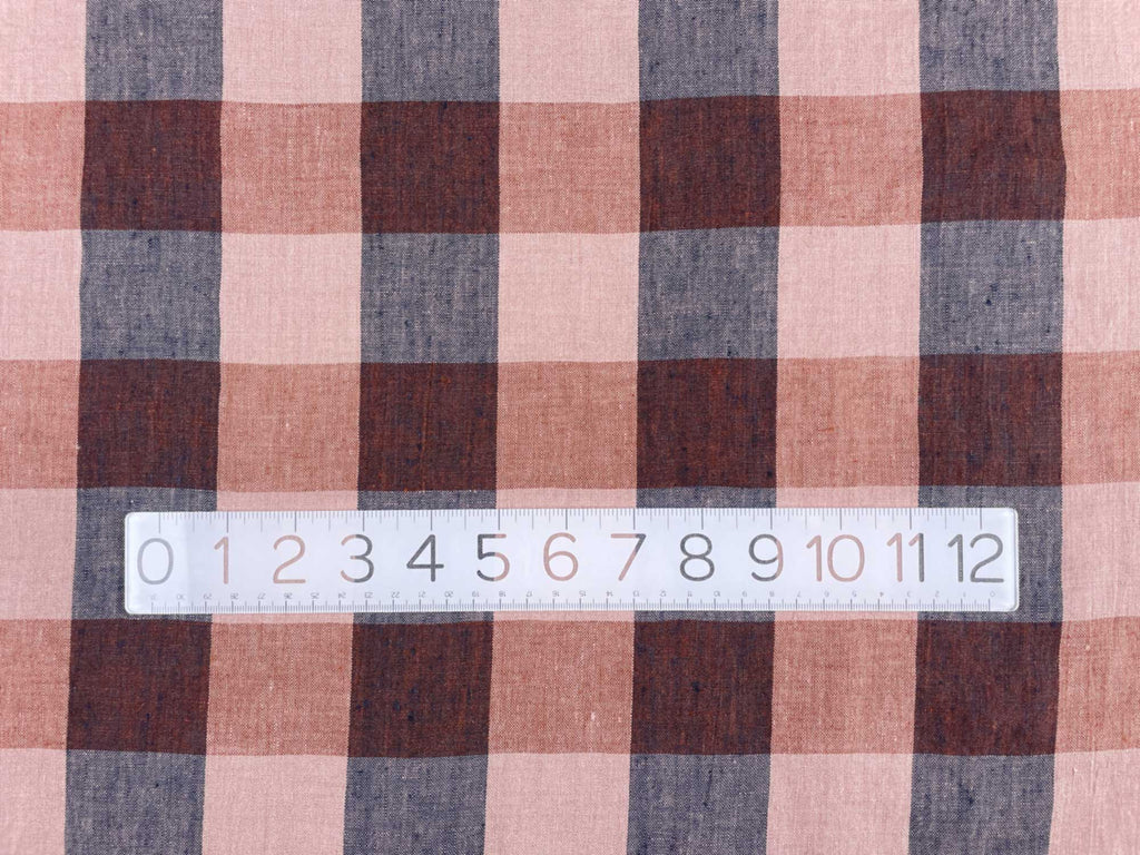 a close up of a measuring tape with a plaid pattern