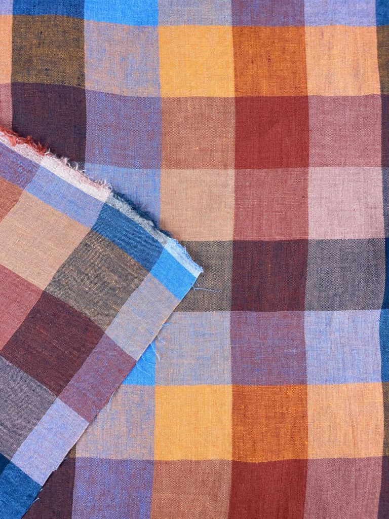 a multicolored checkered fabric with torn edges