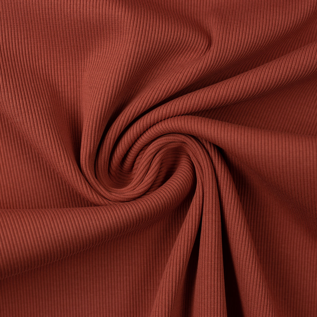Teak colored rib knit fabric gathered into a swirl.