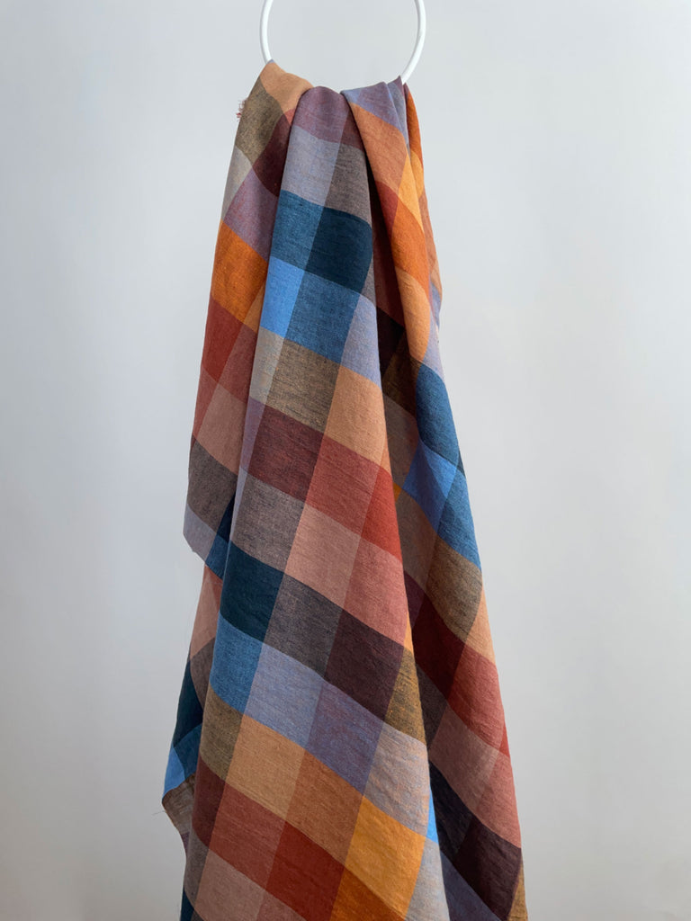 a multicolored blanket hanging on a hook