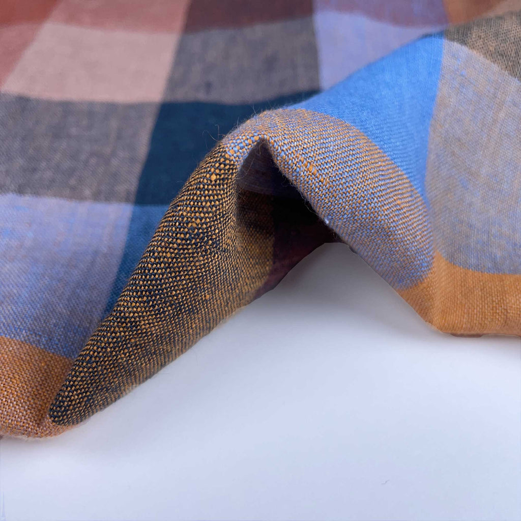 a close up of a checkered fabric on a white surface