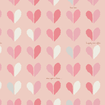 Closeup image of cotton flannel fabric with pink and white hearts and cursive writing.