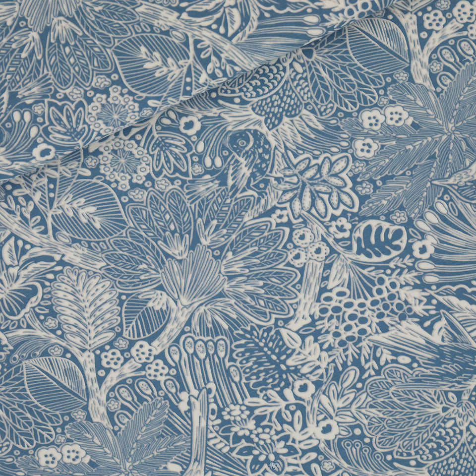Blue fabric printed with birds and leaves.