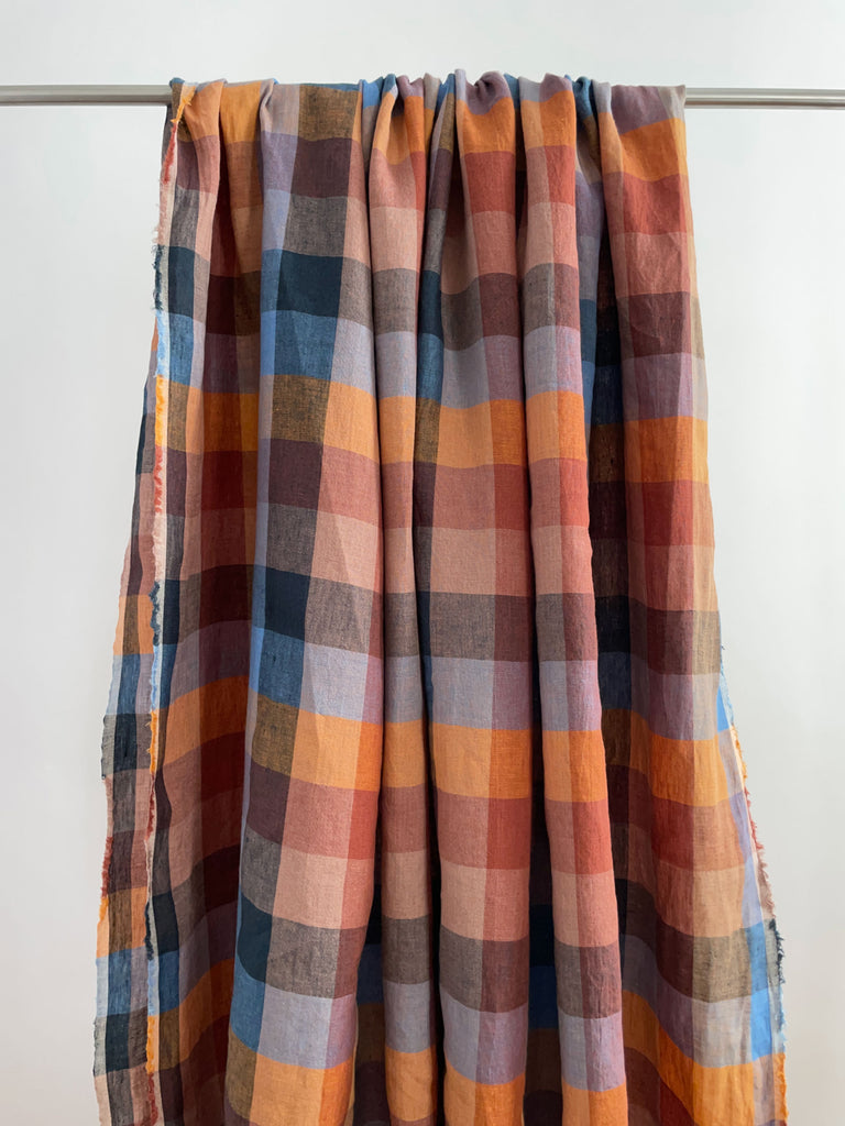 a plaid blanket hanging on a clothes line